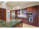 Modern kitchen with stainless steel appliances, custom cabinets, and granite countertops at 40215 N 110Th Pl, Scottsdale, AZ 85262