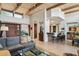 Open-concept living room with wood-beamed ceilings, bar, and comfortable seating at 40215 N 110Th Pl, Scottsdale, AZ 85262