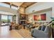Open-concept living room with stone fireplace, comfortable seating and natural light at 40215 N 110Th Pl, Scottsdale, AZ 85262