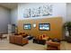 Spacious lounge area with comfortable seating, TVs, and decorative artwork offers a relaxing space to unwind at 40215 N 110Th Pl, Scottsdale, AZ 85262