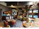 Inviting lounge area with a wet bar, multiple TVs, comfortable seating, and warm, ambient lighting at 40215 N 110Th Pl, Scottsdale, AZ 85262