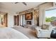 Bright main bedroom features an elegant fireplace, seating area, and access to outdoor spaces at 40215 N 110Th Pl, Scottsdale, AZ 85262