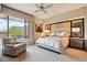 Relaxing primary bedroom features a seating area, a ceiling fan, and outdoor views at 40215 N 110Th Pl, Scottsdale, AZ 85262