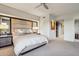 This main bedroom features a ceiling fan, bedside lighting, and neutral decor at 40215 N 110Th Pl, Scottsdale, AZ 85262