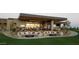 Outdoor dining on the patio offers comfortable seating and multiple TVs for guests to enjoy at 40215 N 110Th Pl, Scottsdale, AZ 85262