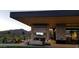 An outdoor patio area is complete with a large fireplace and comfortable couches for residents at 40215 N 110Th Pl, Scottsdale, AZ 85262