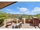 Serene outdoor patio featuring built-in seating, a fire pit, and desert landscape views on a sunny day at 40215 N 110Th Pl, Scottsdale, AZ 85262