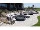 Comfortable outdoor seating surrounds a circular fire pit, perfect for desert evenings at 40215 N 110Th Pl, Scottsdale, AZ 85262