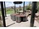 Stylish outdoor seating area with a large wooden table, comfortable chairs, and desert views, perfect for relaxation at 40215 N 110Th Pl, Scottsdale, AZ 85262