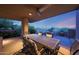 Enjoy outdoor dining on this covered patio with a ceiling fan and scenic views of the surrounding desert landscape at 40215 N 110Th Pl, Scottsdale, AZ 85262