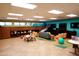 A colorful playroom equipped with tables, chairs, cabinets, and a variety of toys and entertainment at 40215 N 110Th Pl, Scottsdale, AZ 85262