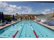 An inviting swimming pool with clear blue water, surrounded by lounge chairs and desert scenery at 40215 N 110Th Pl, Scottsdale, AZ 85262