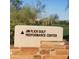 Close up of the Jim Flick Golf Performance Center sign made of stone with a sandy colored background at 40215 N 110Th Pl, Scottsdale, AZ 85262