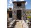 View of a stone archway with plants in pots alongside stone pathway at 40215 N 110Th Pl, Scottsdale, AZ 85262
