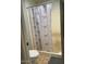 Cozy bathroom featuring a shower with a patterned curtain at 4123 N 106Th N Ave, Phoenix, AZ 85037