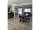 This dining area features a rustic wooden table and chairs, complemented by stylish tiled floors at 4123 N 106Th N Ave, Phoenix, AZ 85037
