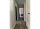 Well-lit hallway with modern flooring, offering seamless transition between rooms at 4123 N 106Th N Ave, Phoenix, AZ 85037