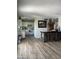 Bright kitchen with tiled floors, white cabinets, and stainless appliances and a bar area at 4123 N 106Th N Ave, Phoenix, AZ 85037