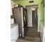 Stainless steel refrigerator in kitchen with white cabinets and view to bathroom at 4123 N 106Th N Ave, Phoenix, AZ 85037
