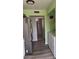 Stainless steel refrigerator with white cabinets and view to laundry room at 4123 N 106Th N Ave, Phoenix, AZ 85037