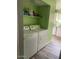 Well-equipped laundry room with a washer, dryer, and shelving for storage at 4123 N 106Th N Ave, Phoenix, AZ 85037