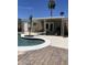 Resort-style pool surrounded by patio, perfect for outdoor entertaining with shade and easy access to house at 4123 N 106Th N Ave, Phoenix, AZ 85037