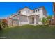 The exterior shows a two-story home with a grassy backyard and covered patio area at 4149 E Devon Dr, Gilbert, AZ 85296
