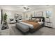 Bright bedroom with a ceiling fan, grey carpet, stylish decor, and a comfortable bed at 4149 E Devon Dr, Gilbert, AZ 85296