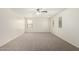 Bright carpeted bedroom with multiple windows and a ceiling fan at 4149 E Devon Dr, Gilbert, AZ 85296