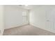 Bedroom with neutral carpet, a window, and a white door at 4149 E Devon Dr, Gilbert, AZ 85296