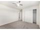 Spacious bedroom with neutral carpet, ceiling fan, and a sliding closet at 4149 E Devon Dr, Gilbert, AZ 85296