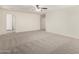 Large carpeted bedroom with neutral walls and a ceiling fan for added comfort at 4149 E Devon Dr, Gilbert, AZ 85296