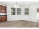 Bright dining area filled with natural light, featuring stylish lighting and wood-look flooring at 4149 E Devon Dr, Gilbert, AZ 85296