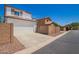 Exterior view of home featuring a two-car garage, driveway, and desert landscaping at 4149 E Devon Dr, Gilbert, AZ 85296