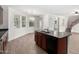 Modern kitchen featuring an island sink, dark cabinets, and open layout into the living space at 4149 E Devon Dr, Gilbert, AZ 85296