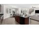 Open kitchen with an island, sink, and dishwasher, offers views of the staircase and living room at 4149 E Devon Dr, Gilbert, AZ 85296