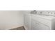 This practical laundry room features a white washer and dryer set for convenient chores at 4149 E Devon Dr, Gilbert, AZ 85296