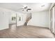 Spacious living room with wood-look floors and staircase access, seamlessly connecting to other areas at 4149 E Devon Dr, Gilbert, AZ 85296