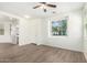 Sunlit living room with modern wood-look floors and neutral decor, offers a versatile layout at 4149 E Devon Dr, Gilbert, AZ 85296