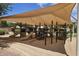 The playground features slides, ladders, and climbing structures under a large shade canopy at 4149 E Devon Dr, Gilbert, AZ 85296