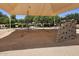 The park features a climbing wall and net structure under a shaded canopy at 4149 E Devon Dr, Gilbert, AZ 85296