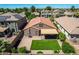Backyard aerial view showcasing a covered patio, artificial turf, and block fence at 42505 W Venture Rd, Maricopa, AZ 85138