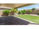 Spacious backyard with covered patio, brick pavers, and artificial turf area at 42505 W Venture Rd, Maricopa, AZ 85138