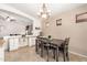 Cozy dining area with tile flooring, neutral walls, and a modern chandelier, perfect for Gathering meals at 42505 W Venture Rd, Maricopa, AZ 85138