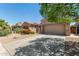 Inviting home with a well-manicured front yard, two-car garage, and a long driveway for ample parking at 42505 W Venture Rd, Maricopa, AZ 85138
