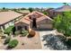Aerial view showcases a charming home with a well-maintained landscape and a two-car garage at 42505 W Venture Rd, Maricopa, AZ 85138
