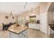 Bright kitchen featuring granite countertops, stainless steel appliances, and an adjacent dining area with outdoor access at 42505 W Venture Rd, Maricopa, AZ 85138