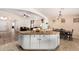 Open-concept kitchen flowing into the dining and living areas, with a large island and tile flooring at 42505 W Venture Rd, Maricopa, AZ 85138