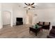 Spacious living room featuring wood-look tile floors, neutral paint, and a seamless flow to other living areas at 42505 W Venture Rd, Maricopa, AZ 85138