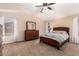 Carpeted main bedroom featuring a wooden bed frame, a dresser, and views from the window at 42505 W Venture Rd, Maricopa, AZ 85138